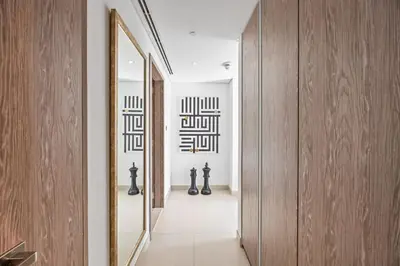 a hallway with a large mirror and a hallway with at Trendy Marina 2-Bedroom Apartment in Dubai