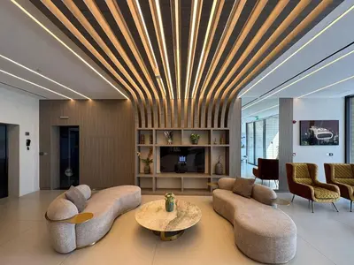 a living room with a couch and a table at Fresh and Modern 1BR Welcome to Asak 11 JVC in Dubai