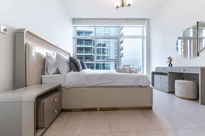 a bedroom with a large bed and a large window at Cozy 2BR Near Zabeel Park - Dubai frame view in Dubai