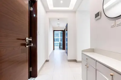 a hallway with a door and a mirror at Cozy 2BR Near Zabeel Park - Dubai frame view in Dubai