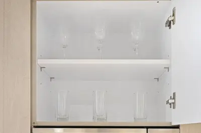 a white cabinet with wine glasses on it at New Stylish Apartment, Metro 5min walk, Dubai Marina 20min in Dubai