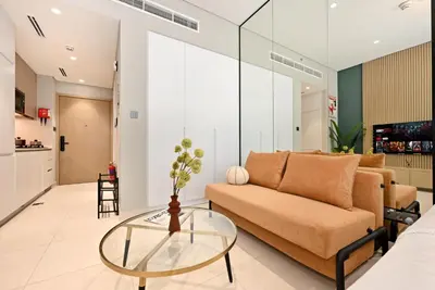 a living room with a couch and a glass table at New Stylish Apartment, Metro 5min walk, Dubai Marina 20min in Dubai