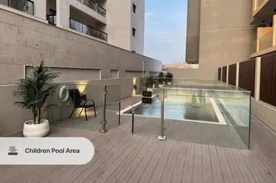 a swimming pool on the side of a building at New Stylish Apartment, Metro 5min walk, Dubai Marina 20min in Dubai