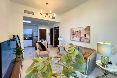 a living room with a couch and a table at Coozy one bedroom in Al Jaddaf Dubai in Dubai