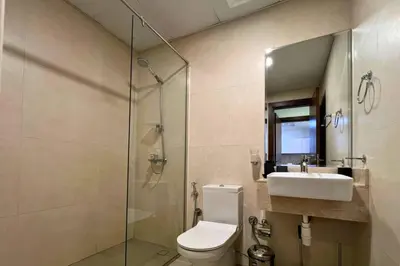 a bathroom with a toilet and a sink and a shower at Coozy one bedroom in Al Jaddaf Dubai in Dubai