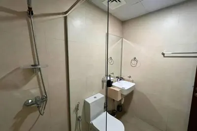a bathroom with a shower and a toilet and a sink at Coozy one bedroom in Al Jaddaf Dubai in Dubai