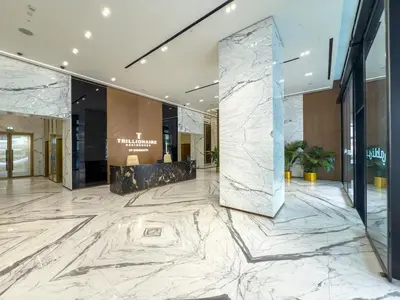 an office lobby with marble flooring and a marble wall at Private Jacuzzi Canal view - Near Burj Khalifa in Dubai