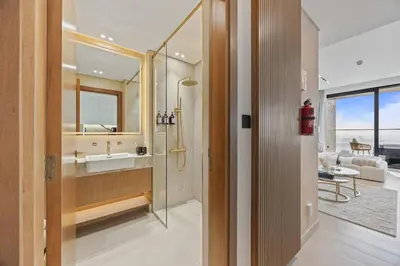 a bathroom with a shower and a sink and a mirror at Private Jacuzzi Canal view - Near Burj Khalifa in Dubai