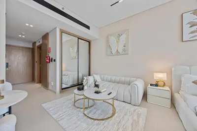 a living room with a couch and a table at Private Jacuzzi Canal view - Near Burj Khalifa in Dubai