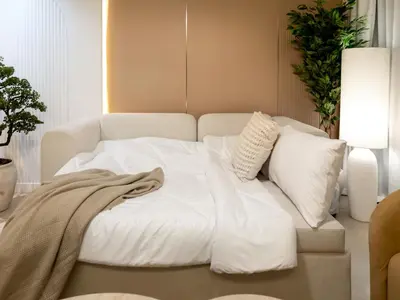 a bed with white sheets and pillows in a room at 2BDR - Burj Khalifa view with Private terrace in Dubai