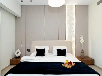 a bedroom with a large bed with a tray on it at 2BDR - Burj Khalifa view with Private terrace in Dubai