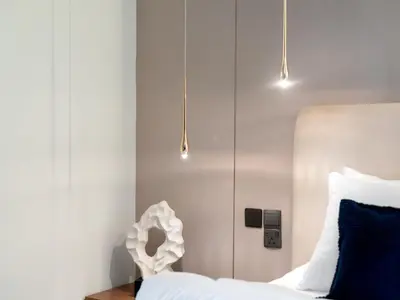 a bedroom with a white bed and two lights at 2BDR - Burj Khalifa view with Private terrace in Dubai