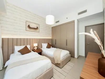 a hotel room with two beds and a table at 2BDR - Burj Khalifa view with Private terrace in Dubai