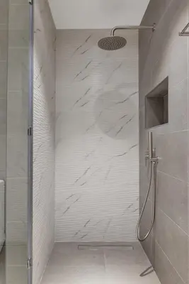 a shower with a glass door in a bathroom at The Torch Cozy 1BR Marina Near JBR & Metro in Dubai