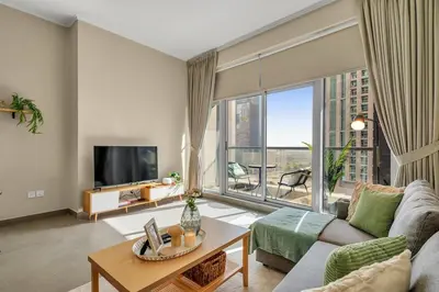 a living room with a couch and a large window at The Torch Cozy 1BR Marina Near JBR & Metro in Dubai