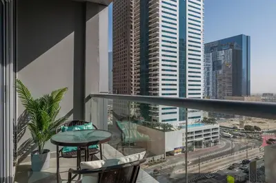 a balcony with a table and a view of a city at The Torch Cozy 1BR Marina Near JBR & Metro in Dubai