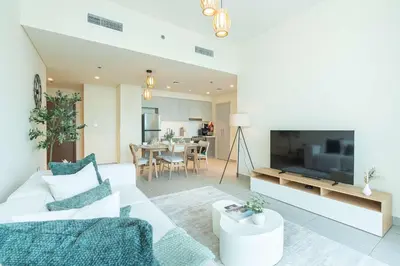 a living room with a white couch and a tv at PVH - Contemporary 1BR Near Burj Khalifa - Forte Tower 2 in Dubai