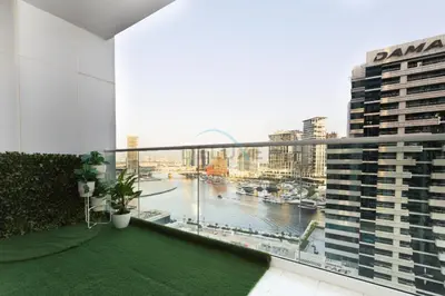 a balcony with a view of a river and buildings at 1BR Facing Canal and City Views, Just a Short Walk to Bus Stop and Marine Transport, Reva Residences, Business Bay by Deluxe Holiday Homes in Dubai