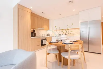 a kitchen with a wooden table and chairs in a room at Stunning View, Easy Access to Dubai Attraction, Beach Vista Tower 2, Emaar Beachfront by Deluxe Holiday Homes in Dubai