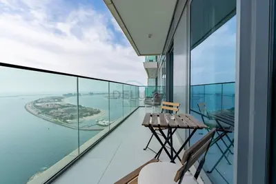 an apartment balcony with a view of the water at Stunning View, Easy Access to Dubai Attraction, Beach Vista Tower 2, Emaar Beachfront by Deluxe Holiday Homes in Dubai