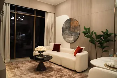 a living room with a white couch and a table at Pearl House 2 in Dubai