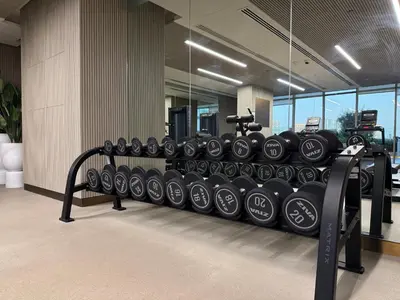 a row of dumbbells on a rack in a gym at Pearl House 2 in Dubai