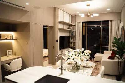 a kitchen and living room with a table with flowers at Pearl House 2 in Dubai