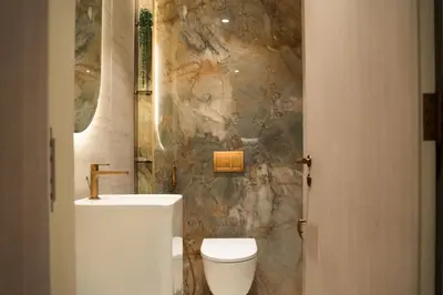 a bathroom with a white toilet and a sink at Pearl House 2 in Dubai