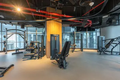 a gym with several treadmills and exercise equipment at StayShort - 1 Bedroom Sleeps 2 with City Views in Business Bay in Dubai