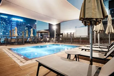 a swimming pool on top of a building at StayShort - 1 Bedroom Sleeps 2 with City Views in Business Bay in Dubai