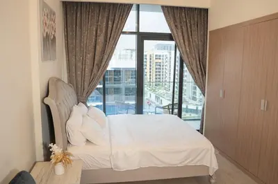 a bedroom with a bed and a large window at Burj Khalifa View Studio 10 mins away Dubai Mall in Dubai