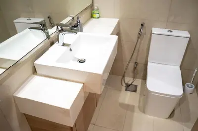a bathroom with a white sink and a toilet at Burj Khalifa View Studio 10 mins away Dubai Mall in Dubai