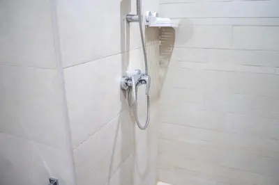 a shower with a shower head in a bathroom at Burj Khalifa View Studio 10 mins away Dubai Mall in Dubai