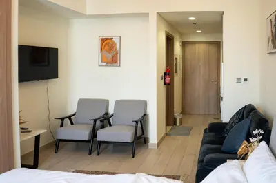 a living room with a couch and chairs at Burj Khalifa View Studio 10 mins away Dubai Mall in Dubai