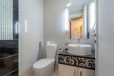 a bathroom with a white toilet and a sink at High floor downtown apartment opposite Dubai Mall in Dubai