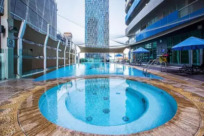 a large swimming pool in the middle of a building at High floor downtown apartment opposite Dubai Mall in Dubai
