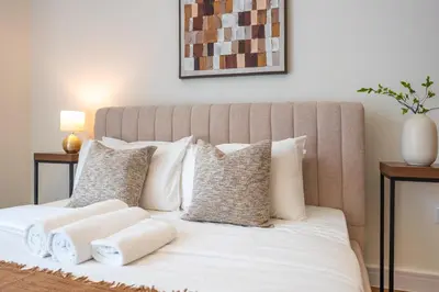 a bedroom with a bed with white pillows at ShoresInn - Luxury Dubai Creek Harbour Stay in Dubai