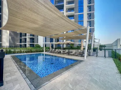 a swimming pool with a canopy over a building at ShoresInn - Luxury Dubai Creek Harbour Stay in Dubai