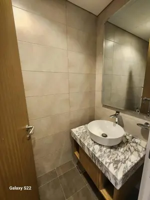 a bathroom with a sink and a mirror at Majestic Canal View 2Bhk 6pax in Dubai