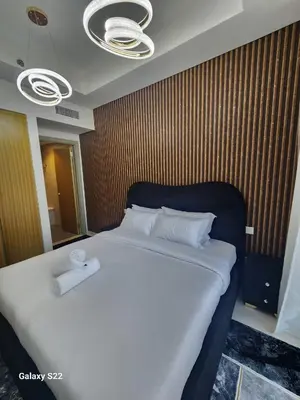 a bedroom with a large bed with two towels on it at Majestic Canal View 2Bhk 6pax in Dubai