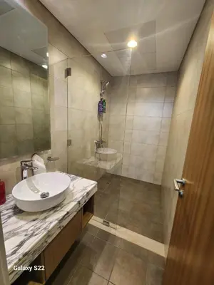 a bathroom with a sink and a shower at Majestic Canal View 2Bhk 6pax in Dubai