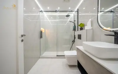 a bathroom with a shower and a sink and a toilet at Deluxe Beach Residence 2Bhk, 8pax in Dubai