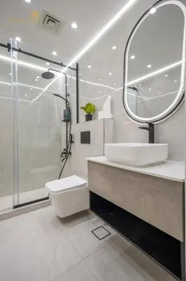 a bathroom with a sink and a toilet and a mirror at Deluxe Beach Residence 2Bhk, 8pax in Dubai