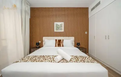 a bedroom with a large white bed in a room at Deluxe Beach Residence 2Bhk, 8pax in Dubai