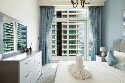 a bedroom with a large window and a large bed at 2 Bedroom Apartment in Emaar Beachfront with Palm and Marina Views in Dubai