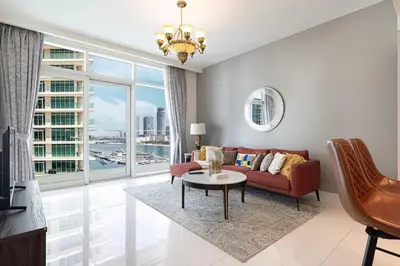 a living room with a couch and a table at 2 Bedroom Apartment in Emaar Beachfront with Palm and Marina Views in Dubai