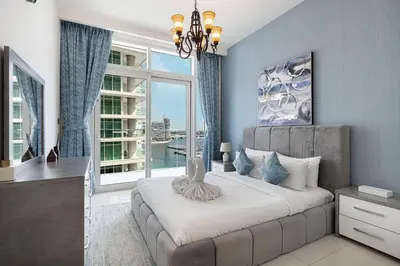 a bedroom with a large bed and a large window at 2 Bedroom Apartment in Emaar Beachfront with Palm and Marina Views in Dubai