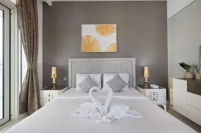a bedroom with a bed with a swan decoration on it at 2 Bedroom Apartment in Emaar Beachfront with Palm and Marina Views in Dubai