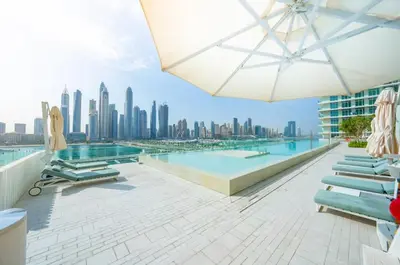 a swimming pool with a view of the city at 2 Bedroom Apartment in Emaar Beachfront with Palm and Marina Views in Dubai