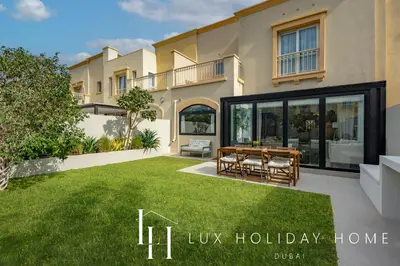 a villa with a dining table in a yard at LUX The Serene Springs Villa in Dubai